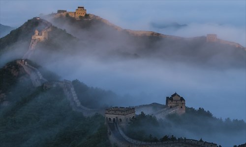 Jinshanling, the best preserved section of the Great Wall, meanders along a mountain ridge in Chengde, North China’s Hebei Province on Tuesday, emerging like a dragon partly hidden amid the clouds. The oldest section of the Jinshanling wall was built in 1368, during the Ming Dynasty (1368-1644). Photo: CFP