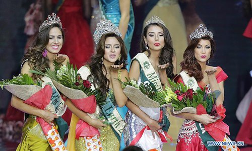 Miss Ecuador Katherine Espin (2nd L), newly crowned Miss Earth 2016, reacts during the coronation night along with other contestants in Pasay City, the Philippines, Oct. 29, 2016. A total of 84 contestants vied for the Miss Earth 2016 crown to promote environmental awareness. Photo:Xinhua