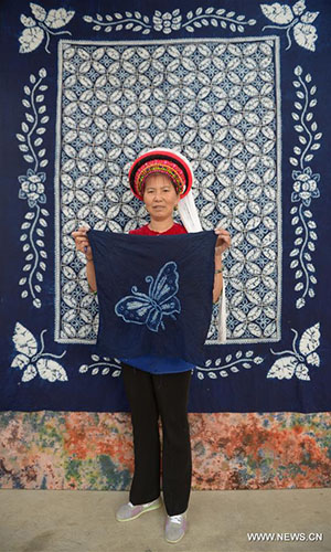 Artisan Duan Hua'ai shows a tie-dyeing product in Dali, southwest China's Yunnan Province, Nov. 15, 2016. As a traditional folk technique of the Bai ethnic group, tie dyeing was listed in 2006 into state-level intangible cultural heritages. The technique goes through three major steps: making knots, dipping and dyeing, and drying in the sun. The pattern of the cloth is simple and natural, which looks graceful, but not extravagant. Traditional tie-dyeing products are mostly inspired by local scenery and based on blue and white colors. (Xinhua/Ding Yiquan) 