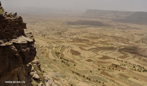 Yemeni workers repair walks of the Thula Fort at the historical city of Thula, 45 km north of Sanaa, Yemen, on May 12, 2013. Thula Fort is one of 20 nominees for the 2013 Aga Khan Award for Architecture which is given every three years to projects that set new standards of excellence in architecture, planning practices, historic preservation and landscape architecture, in which Muslims have a significant presence. Thula boasts an impressive collection of stone buildings that date back to the 1st millennium BCE. The Thula fort was threatened by the disruption that might ensue from the construction of a road. However, the Yemeni government has undertaken a series of historic preservation projects to protect cultural assets, including rebuilding the walls of burial grounds, watch towers, paths and waterways, and repairing the cistern that remains in use to this day.(Xinhua/Mohammed Mohammed) 