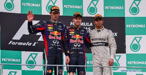 Red Bull driver Sebastian Vettel of Germany (C) poses on the podium with teammate Mark Webber (L) of Australia and Mercedes' Lewis Hamilton of Britain after the Malaysian F1 Grand Prix at Sepang International Circuit outside Kuala Lumpur, Malaysia, March 24, 2013. (Xinhua/Chong Voon Chung) 