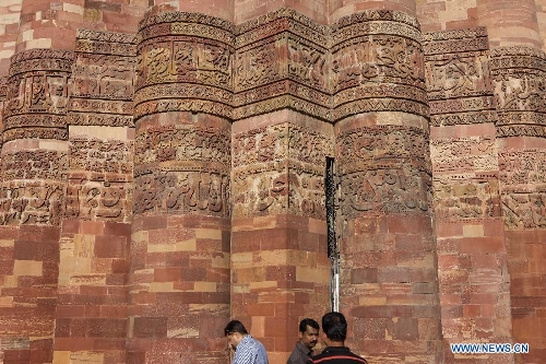 People visit the Qutab Minar in New Delhi, India, on April 5, 2013. Qutab Minar, a UNESCO World Heritage Site, is the tallest minaret in India. It is 75.56 metres high with a base a diameter of 14.3 metres, which narrows to 2.7 metres at the top storey. The minar is made of red sandstone and marble, and covered with intricate carvings. The construction of Qutab Minar started in 1193 by Qutub-ud-din Aibak and was completed by his inheritor Iltutmish. It is surrounded by several other ancient and medieval structures and ruins, collectively known as the Qutub complex, which attracts many visitors till now. (Xinhua/Zheng Huansong) 