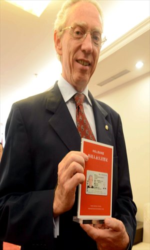 A foreigner shows his newly acquired permanent residence permit, China's green card. Photo: CFP 
