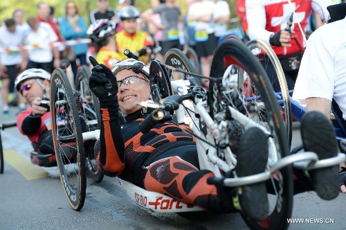 Swiss wheelchair athlete Heinz Frei reacts during the Half Marathon Handbike and armchair race of the 9th Geneva Marathon in Geneva, Switzerland, May 5, 2013. Swiss wheelchair athlete Heinz Frei claimed the title with 35:53:03. (Xinhua/Wang Siwei) 