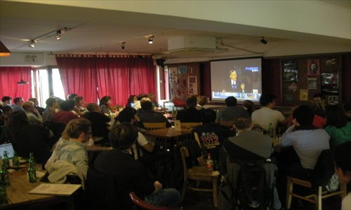 Expats at Bridge Café in Wudaokou, Haidian district, watch live coverage of US President Barack Obama's victory speech on November 7. Photo: Courtesy of Nell Chen 