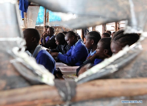 Pupils have a mathematics course at Mcedo Beijing School in Nairobi, capital of Kenya, April 11, 2013. Mcedo Beijing School is located in Mathare slum, one of the largest slums in Kenya and home to about 500,000 residents. The school offered mathematics, English, Swahili, science and some other courses for over 600 students living in three nearby regions. Pupils got free lunch in the school thanks to the United Nations World Food Programme. (Xinhua/Meng Chenguang) 