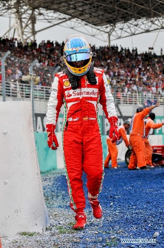 Ferrari driver Fernando Alonso of Spain leaves the track during the Malaysian F1 Grand Prix at Sepang International Circuit outside Kuala Lumpur, Malaysia, March 24, 2013. (Xinhua/Chong Voon Chung) 