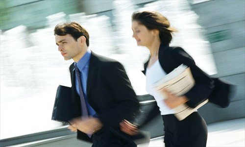 Busy staff head back to work with files. Photo: CFP