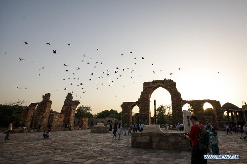 People visit the Qutab Minar in New Delhi, India, on April 5, 2013. Qutab Minar, a UNESCO World Heritage Site, is the tallest minaret in India. It is 75.56 metres high with a base a diameter of 14.3 metres, which narrows to 2.7 metres at the top storey. The minar is made of red sandstone and marble, and covered with intricate carvings. The construction of Qutab Minar started in 1193 by Qutub-ud-din Aibak and was completed by his inheritor Iltutmish. It is surrounded by several other ancient and medieval structures and ruins, collectively known as the Qutub complex, which attracts many visitors till now. (Xinhua/Zheng Huansong) 