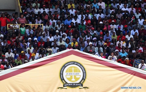 Civilians attend Uhuru Kenyatta's inauguration ceremony at Moi International Sports Center in Nairobi, capital of Kenya, April 9, 2013. Kenya's President Uhuru Kenyatta officially took office on Tuesday after being sworn into office as the East African nation's fourth president. (Xinhua/Meng Chenguang)