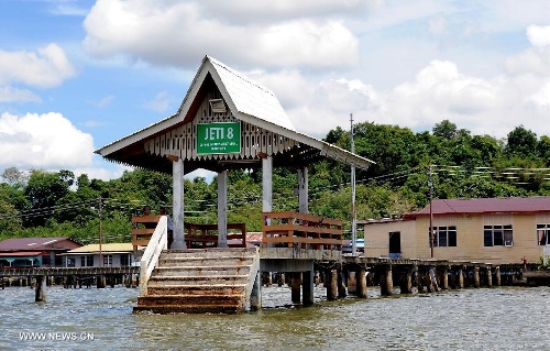 Photo taken on April 24, 2013 shows a wharf of the Water Village in Brunei's capital city Bandar Seri Begawan. Dubbed as Venice of the East and situated along the Brunei River, Kampong Ayer is the world's largest water village, sheltering about 30,000 inhabitants. It covers an area of 2.6 square kilo-meters and consists of 10 villages whose building are constructed on the Brunei River. (Xinhua/He Jingjia) 