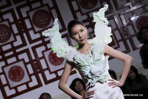 A model displays a creation by Chinese designer Xu Ming at Chinese Cultural Center in Paris, France, Feb. 25, 2013. (Xinhua/Gao Jing) 