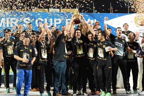 Players of Qadsia celebrate with their trophy after winning the Amir Cup final against Jahra in Kuwait City, capital of Kuwait, May 28, 2013. Qadsia won the match 3-0. (Xinhua/Noufal Ibrahim) 