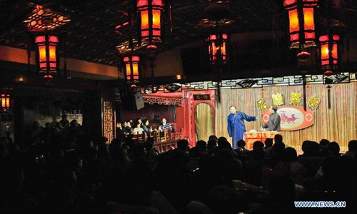 Cross talk actors perform on stage at a teahouse in Tianjin, north China, January 2, 2013.