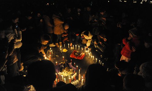 Residents in Changchun, capital of Northeast China's Jilin Province, light candles to mourn Xu Haobo, who was reportedly killed by a local car thief on Tuesday. The murderer has turned himself in, yet public outrage is still mounting. Photo: CFP