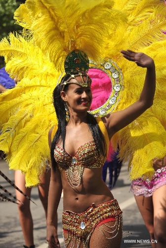 A samba dancer from Brazil performs at a carnival during the China Kunming Culture and Tourism Festival in Kunming, capital of southwest China's Yunnan Province, April 29, 2013. (Xinhua/Lin Yiguang)  