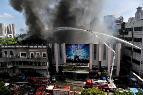 Smokes rise from a burning four-story commercial building in Liuzhou, south China's Guangxi Zhuang Autonomous Region, July 1, 2013. Twelve fire trucks and 49 firefighters have been dispatched to fight the blaze. No casualties have been reported thus far. (Xinhua) 