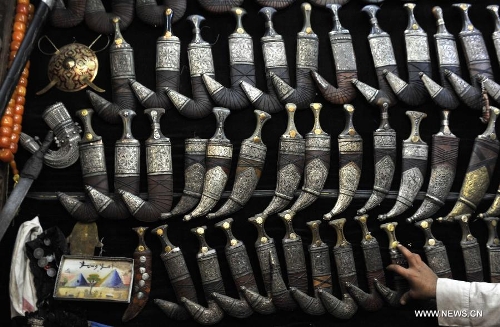 A vendor shows traditional souvenirs at his shop in the Old City of Sanaa, Yemen, on March 24, 2013. According to local media, Yemen's tourism sector suffered losses estimated at one billion U.S. dollars following the 2011 crisis. Vendors in the Old City of Sanaa, a UNESCO World Heritage Site, said the number of foreign tourists declined by at least 90 percent due to the 2011 unrest that severely undermines security in Yemen. (Xinhua/Mohammed Mohammed) 