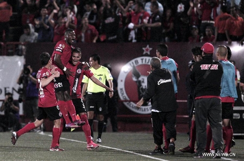  Players of Tijuana's Xolos celebrate scoring against Chivas during a Liga MX soccer match held in Tijuana, Mexico, on May 3, 2013. (Xinhua/Guillermo Arias) 