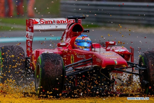 Ferrari driver Fernando Alonso of Spain drives on the gravel during the Malaysian F1 Grand Prix at Sepang International Circuit outside Kuala Lumpur, Malaysia, March 24, 2013. (Xinhua/Chong Voon Chung) 