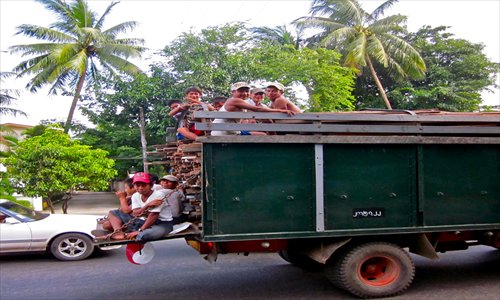 A group of young men ride in the back of a truck. Photos: CFP and Bridget Riley/GTPhoto: Bridget Riley/GT