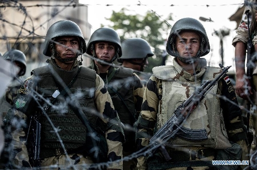 Soldiers guard outside the Republican Guards headquarters as supporters of ousted Egyptian president Mohamed Morsi protest in Nasr city, Cairo, Egypt, July 6, 2013. (Xinhua/Li Muzi) 