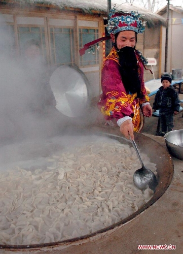 An actor acting as the Kitchen God boils dumplings for citizens during a temple fair in Zhengzhou, capital of central China's Henan Province, Jan. 28, 2006. In Chinese mythology, the Kitchen God is the most important of a plethora of Chinese domestic gods that protect the hearth and family. It is believed that on the 23rd day of the 12th lunar month, just before Chinese Lunar New Year he returns to Heaven to report the activities of every household over the past year to the Jade Emperor. The Jade Emperor, emperor of the heaven, either rewards or punishes a family based on Kitchen God's yearly report. (Xinhua/Wang Song) 