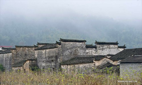 Photo taken on Nov. 10, 2012 shows ancient residential buildings near Tachuan scenic spot in the Huangshan Mountain area, east China's Anhui Province. The beautiful scenery of Huangshan Mountain in the early winter has attracted many tourists. Photo: Xinhua