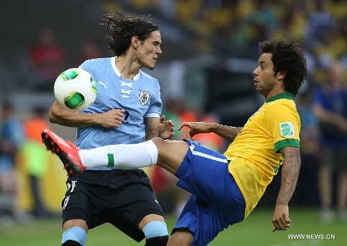 Brazil's Marcelo (R) vies for the ball with Edinson Cavani (L) of Uruguay, during the FIFA's Confederations Cup Brazil 2013 semifinal match, held at Mineirao Stadium, in Belo Horizonte, Minas Gerais state, Brazil, on June 26, 2013. (Xinhua/Liao Yujie)