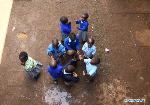 Pupils play on the schoolyard at Mcedo Beijing School in Nairobi, capital of Kenya, April 11, 2013. Mcedo Beijing School is located in Mathare slum, one of the largest slums in Kenya and home to about 500,000 residents. The school offered mathematics, English, Swahili, science and some other courses for over 600 students living in three nearby regions. Pupils got free lunch in the school thanks to the United Nations World Food Programme. (Xinhua/Meng Chenguang) 