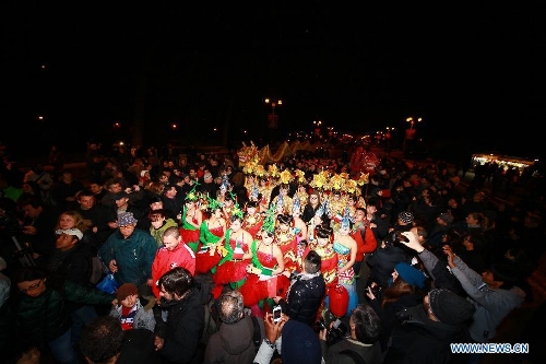 People parade with performers during the 