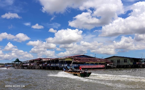 A boat steers towards the Water Village in Brunei's capital city Bandar Seri Begawan, April 24, 2013. Dubbed as Venice of the East and situated along the Brunei River, Kampong Ayer is the world's largest water village, sheltering about 30,000 inhabitants. It covers an area of 2.6 square kilo-meters and consists of 10 villages whose building are constructed on the Brunei River. (Xinhua/Li Peng) 