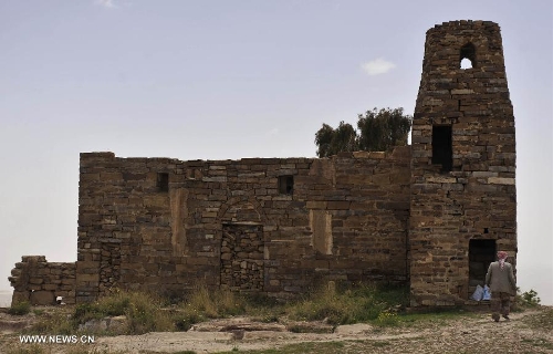 A Yemeni passes an old building at the Thula Fort at the historical city of Thula, 45 km north of Sanaa, Yemen, on May 12, 2013. Thula Fort is one of 20 nominees for the 2013 Aga Khan Award for Architecture which is given every three years to projects that set new standards of excellence in architecture, planning practices, historic preservation and landscape architecture, in which Muslims have a significant presence. Thula boasts an impressive collection of stone buildings that date back to the 1st millennium BCE. The Thula fort was threatened by the disruption that might ensue from the construction of a road. However, the Yemeni government has undertaken a series of historic preservation projects to protect cultural assets, including rebuilding the walls of burial grounds, watch towers, paths and waterways, and repairing the cistern that remains in use to this day.(Xinhua/Mohammed Mohammed) 