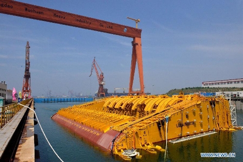 Photo taken on July 3, 2013 shows a buoy of the newly-built deep-sea engineering equipment in Qingdao, east China's Shandong Province. With four sets of buoys and 16 sets of foundations, the deep-sea engineering equipment, the world's largest of this kind, was built and delivered by Wuchang Shipbuilding Industry Co., Ltd. to Petrobras as part of the Sapinhoa-Lula NE BSR Buoys & Foundations Project, which will be installed in an offshore oilfield in Brazil to work for a period of 27 years. The equipment is able to fit in deeper and more complicated marine environment and has extensively enlarged the scope of offshore oil exploitation, said Victor Bomfim, senior vice president of the project contractor Subsea 7 S.A. (Xinhua/Wan Houde) 