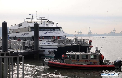 Rescue teams work at the accident site where a ferry boat crashed into Pier 11 in lower Manhattan, New York, the United States, on Jan. 9, 2013. A high-speed ferry loaded with hundreds of commuters from New Jersey crashed into a dock near Wall Street on Wednesday during the morning rush hour, injuring 57 people. (Xinhua/Shen Hong) Related:57 injured in NY ferry crash, 2 criticalNEW YORK, Jan. 9 (Xinhua) -- At least 57 people were injured, two critically, when a ferry crashed into a dock Wednesday morning in Lower Manhattan, New York City, local authorities told Xinhua.The boat, Seastreak Wall Street, with 326 on board including five crew, departed from Highlands, New Jersey at 8:00 a.m. and was scheduled to reach Pier 11 on the lower east coast of Manhattan 45 minutes. However, five minutes prior to docking, it 