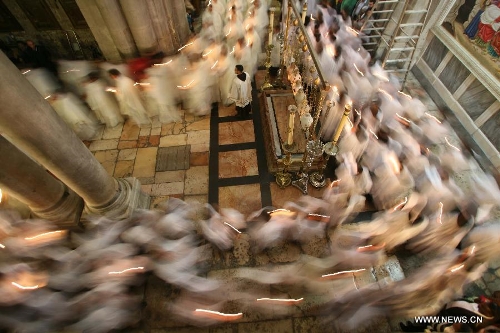 Members of the Catholic clergy hold candles as they take part in a procession at the Catholic Washing of the Feet ceremony in the Church of the Holy Sepulchre in Jerusalem's Old City during Holy Week on March 28, 2013. Holy Week is celebrated in many Christian traditions during the week before Easter. (Xinhua/Muammar Awad)