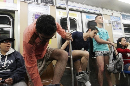 People take off their pants as they take part in the annual 