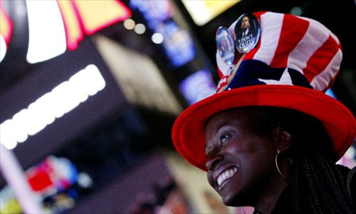 A supporter of U.S. President Barack Obama reacts as she watches election results broadcast confirming the re-election of President Barack Obama in New York, November 6, 2012. Photo: Xinhua