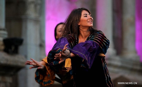 Performers participate in the opening ceremony of Jordan's annual Jerash Festival, hosted in the ancient Greco-Roman city, 45 km north of Amman, on June 26, 2013. (Xinhua/Mohammad Abu Ghosh) 