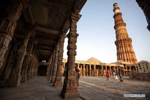 People visit the Qutab Minar in New Delhi, India, on April 5, 2013. Qutab Minar, a UNESCO World Heritage Site, is the tallest minaret in India. It is 75.56 metres high with a base a diameter of 14.3 metres, which narrows to 2.7 metres at the top storey. The minar is made of red sandstone and marble, and covered with intricate carvings. The construction of Qutab Minar started in 1193 by Qutub-ud-din Aibak and was completed by his inheritor Iltutmish. It is surrounded by several other ancient and medieval structures and ruins, collectively known as the Qutub complex, which attracts many visitors till now. (Xinhua/Zheng Huansong) 