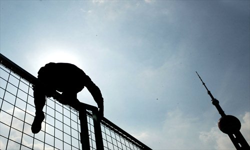 Construction workers sweat under the scorching sun in Pudong New Area. Photo: CFP