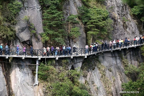 Tourists visit the Sanqing Mountain in east China's Jiangxi Province, April 13, 2013. The scenic area of Sanqing Mountain entered a peak tourist season as temperature rises recently. (Xinhua/Zhou Ke)  