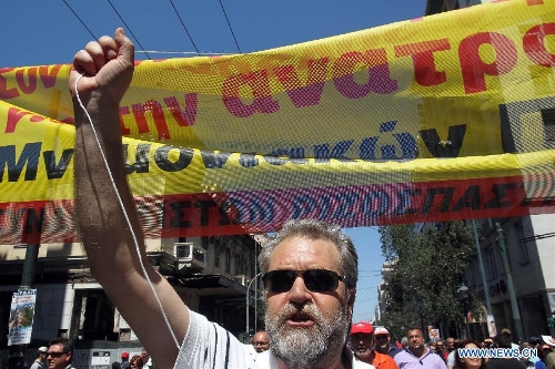 Protesters shout slogans and hold banners in front of the House of Parliament, in Athens, Greece, May 1, 2013. Greece is in the grip of a new 24-hour general strike on Wednesday, as the country's largest unions of public and private sector workers ADEDY and GSEE mark Labor Day with anti-austerity rallies in central Athens and other major cities. (Xinhua/Marios Lolos)  