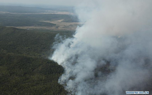 Smoke and fire are seen in the Greater Hinggan Mountains in northeast China's Heilongjiang Province, June 2, 2012. A forest fire that started Saturday morning on a nature reserve in northeast China's Heilongjiang Province was put out at around 8 pm, according to the local forest fire prevention headquarters. Photo: Xinhua