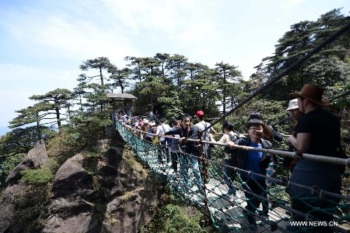 Tourists visit the Sanqing Mountain in east China's Jiangxi Province, April 13, 2013. The scenic area of Sanqing Mountain entered a peak tourist season as temperature rises recently. (Xinhua/Zhou Ke)