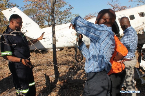 An accident investigator addresses media by the wreckage of a South African registered cargo aircraft that crashed on Saturday 7km northwest of the Francistown International Airport in the northeastern part of Botswana just before it landed, July 2, 2013. Botswana's Aircraft Accident Investigating Unit within the country's Ministry of Transport and Communications on Tuesday announced that investigations into last Saturday's plane crash in the northeastern part of Botswana are ongoing. (Xinhua) 