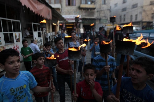 Palestinian boys holding torches take part in a rally in the West Bank city of Nablus on May 14, 2013, to mark Nakba Day on May 15, the annual day of commemoration of the displacement of Palestinians after the establishment of the state of Israel in 1948. (Xinhua/Nidal Eshtayeh) 