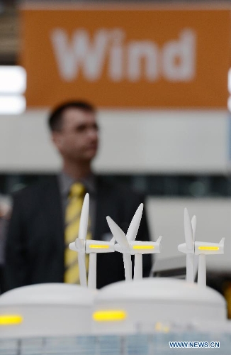 Visitors look at windmill models during the Hannover Industrial Exposition in Hannover, Germany, on April 8, 2013. With the theme of Integrated Industry, Hannover Messe 2013 has attracted the participation of approximately 6,500 exhibitors, making this year's exposition the largest in recent ten years. (Xinhua/Ma Ning) 