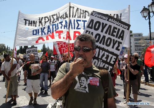 Protesters shout slogans and hold banners in front of the House of Parliament, in Athens, Greece, May 1, 2013. Greece is in the grip of a new 24-hour general strike on Wednesday, as the country's largest unions of public and private sector workers ADEDY and GSEE mark Labor Day with anti-austerity rallies in central Athens and other major cities. (Xinhua/Marios Lolos)  