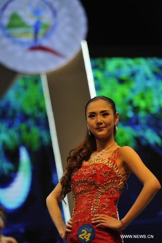 Tan Shiyu, the second-prize winner, performs during the final match of the 2013 Miss Tourism International (Guizhou) in Guiyang, capital of southwest China's Guizhou Province, April 9, 2013. The final match, with the participation of 31 competitors, closed here Tuesday. (Xinhua/Ou Dongqu)